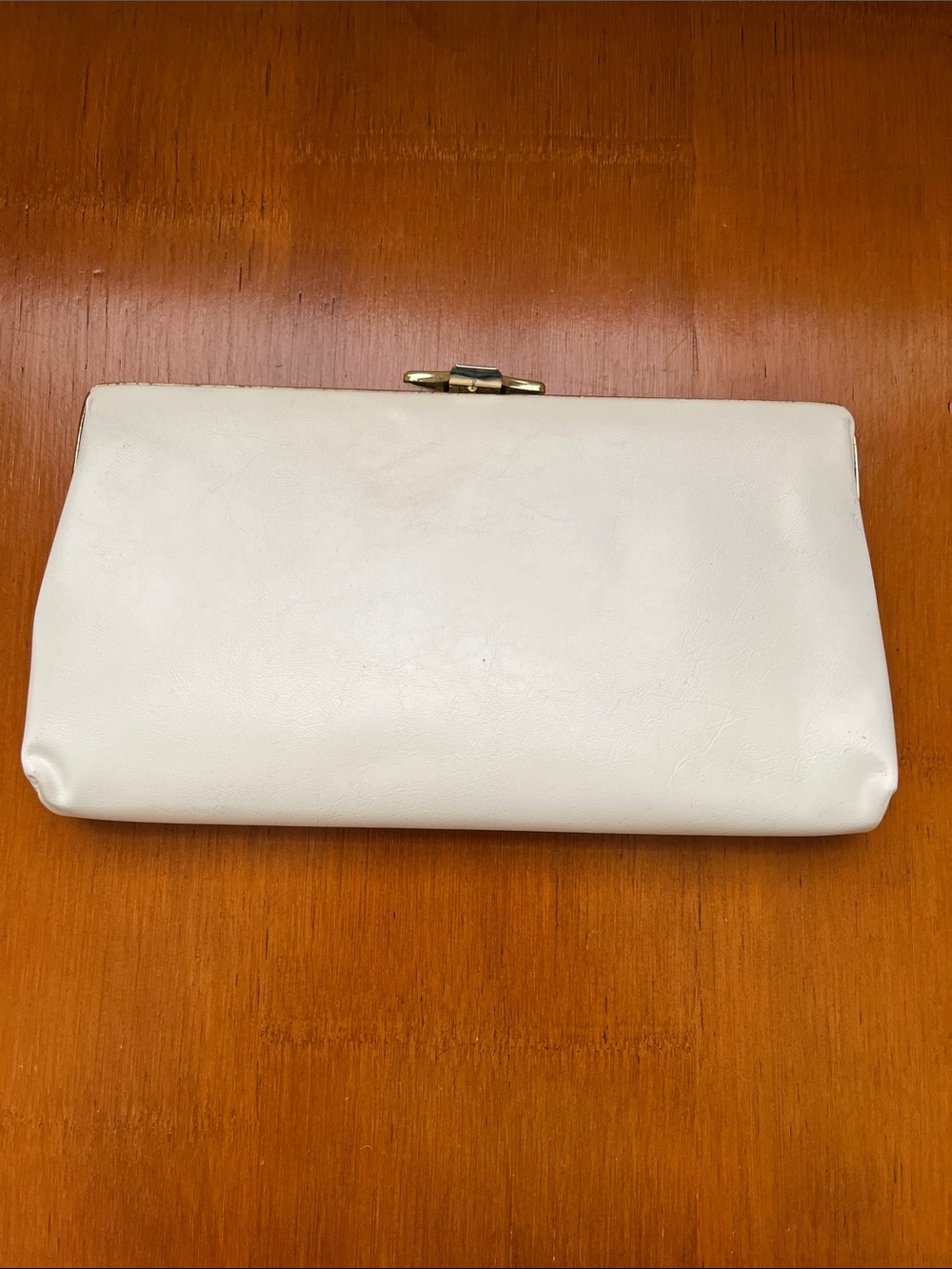 Small cream clutch purse.